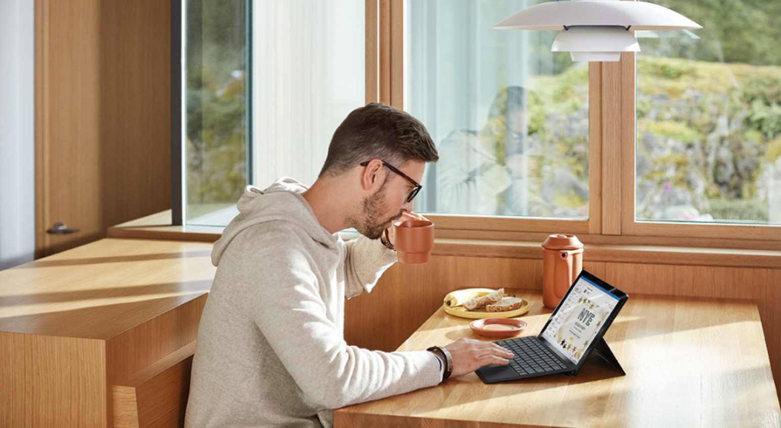 A lady working her Surface Laptop at home